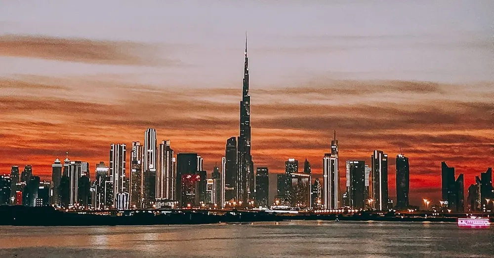 Dubai skyline and Burj Khalifa against an orange sunset