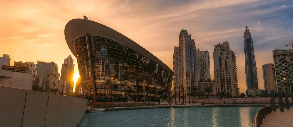 Dubai Opera’s curved exterior beside surrounding towers