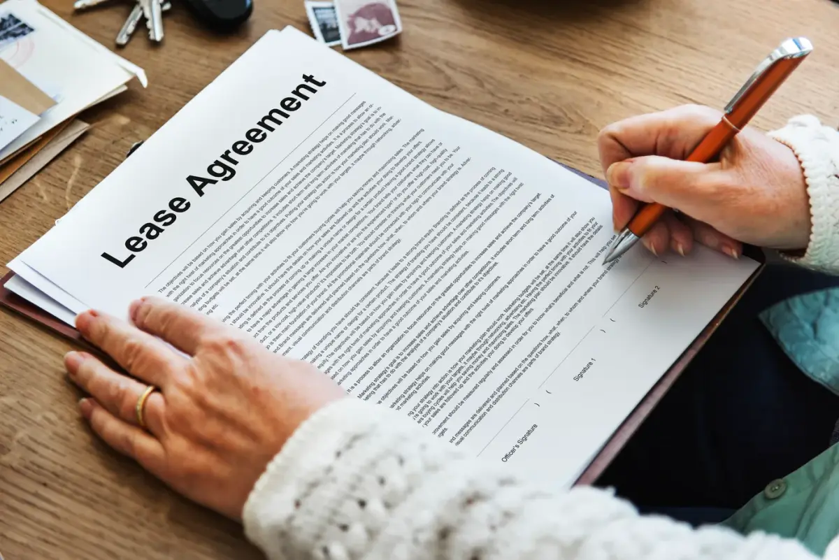 Person signing a document headed Lease Agreement