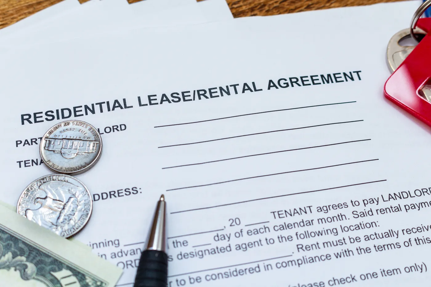 Keys and pen resting on a residential lease form